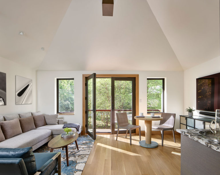 guest suite sitting area with balcony in vintage car garage