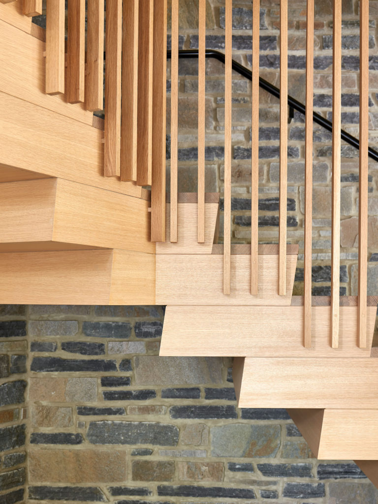 detail of custom-designed contemporary wooden stair in vintage car garage