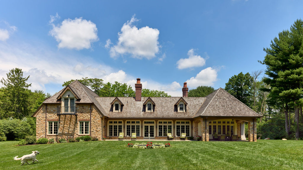 rear exterior of English cottage style home