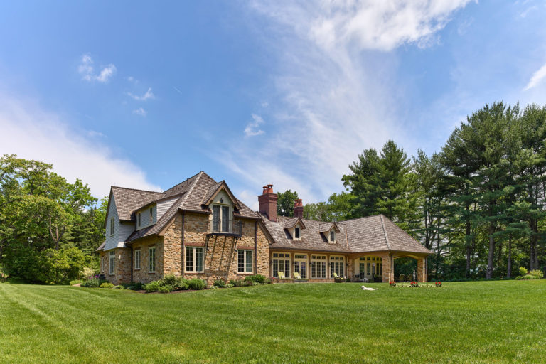 rear exterior of English cottage style home