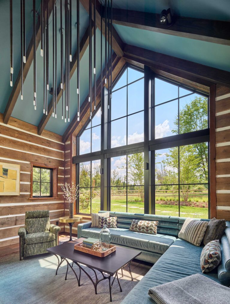 Contemporary den with vaulted ceiling, exposed beams and large windows