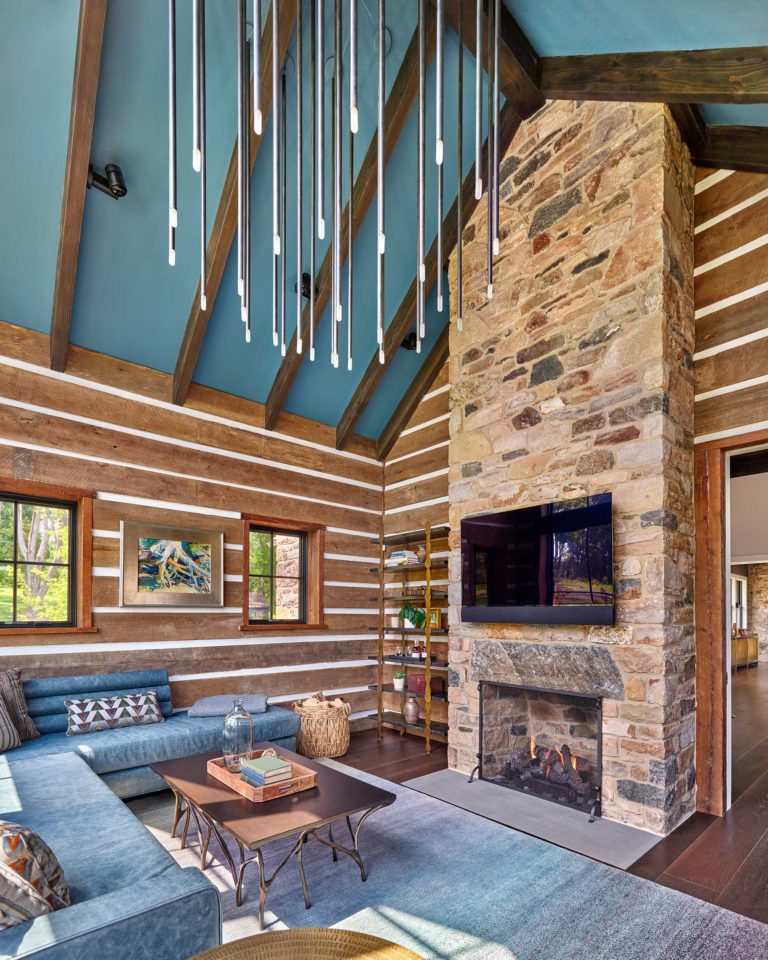Contemporary den with vaulted ceiling, exposed beams and fireplace