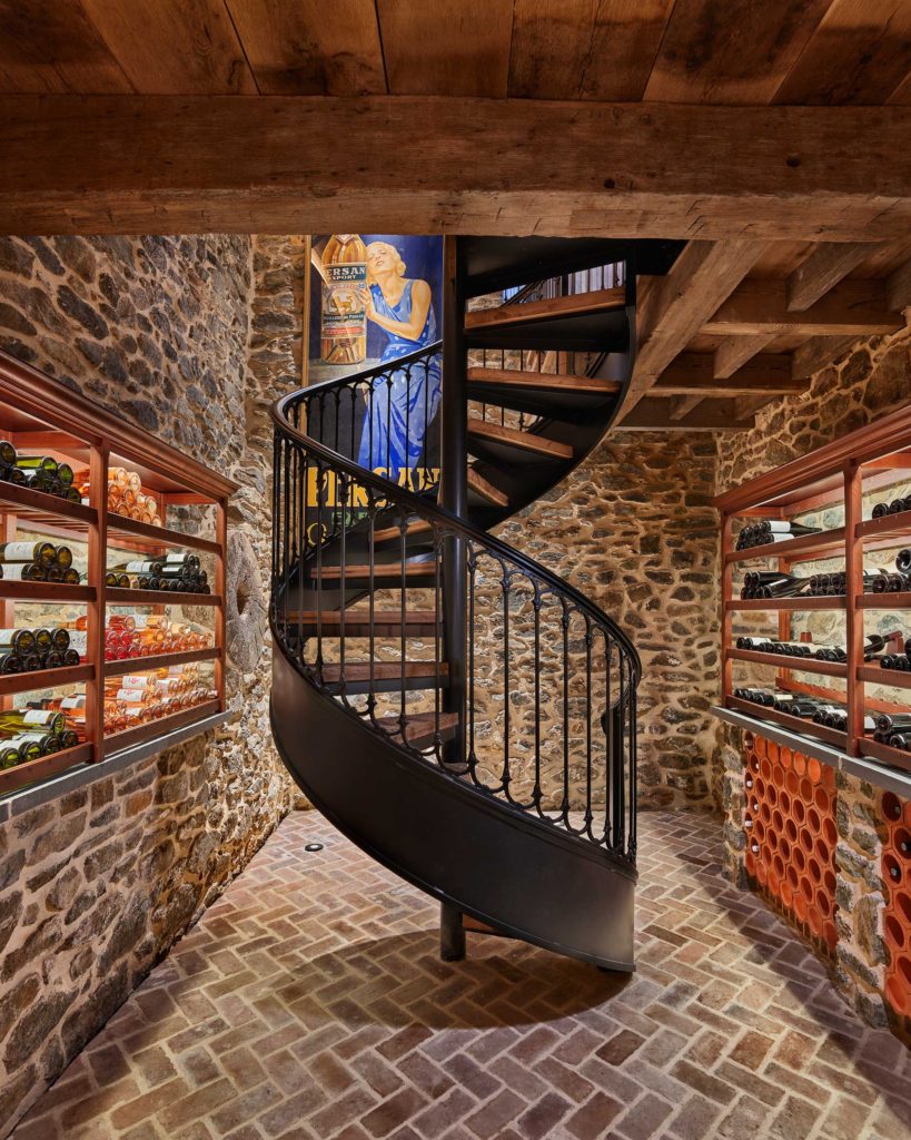 custom iron spiral stair in wine cellar
