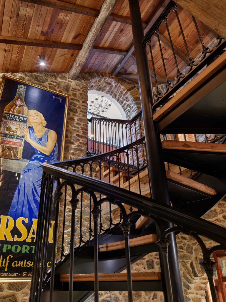 custom iron rail and spiral stair in wine cellar