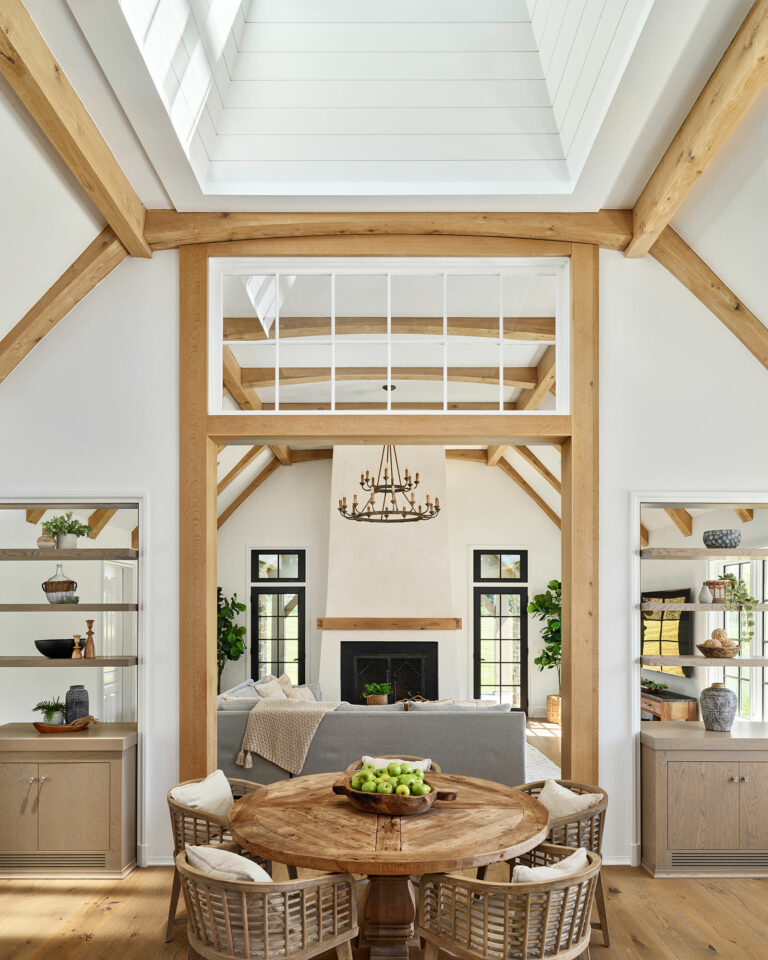 Chestnut Fields, a contemporary farmhouse in Chester County with fireplace, wood mantel, black frame windows and timber frame vaulted ceiling