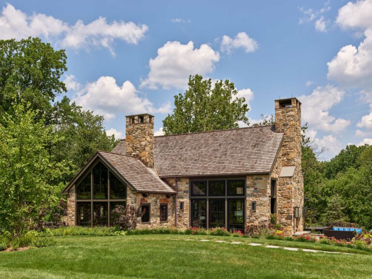 Exterior of new stone contemporary farm house with cedar shake roof in New Hope Pennsylvania