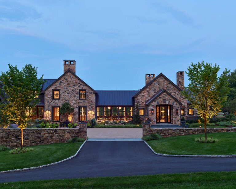 Entrance court of new contemporary farm house in New Hope at dusk