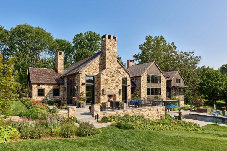 Terrace and outdoor fireplace at stone and wood new contemporary farm house in New Hope Pennsylvania