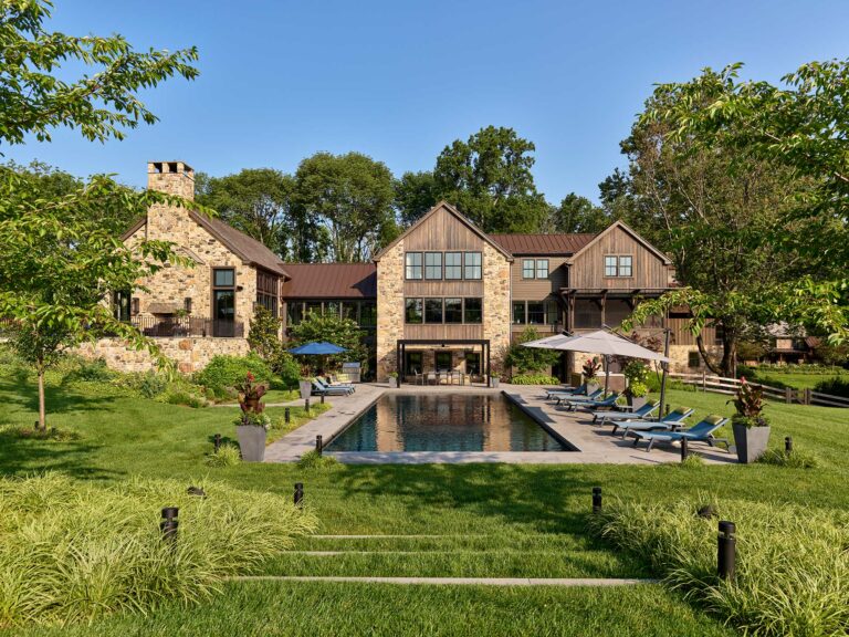 Pool and patio of stone and wood contemporary farm house in New Hope, Pennsylvania