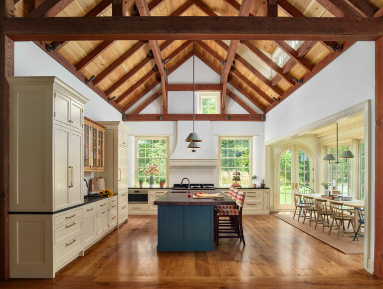 Timber frame kitchen addition with vaulted ceiling, large blue island and breakfast room