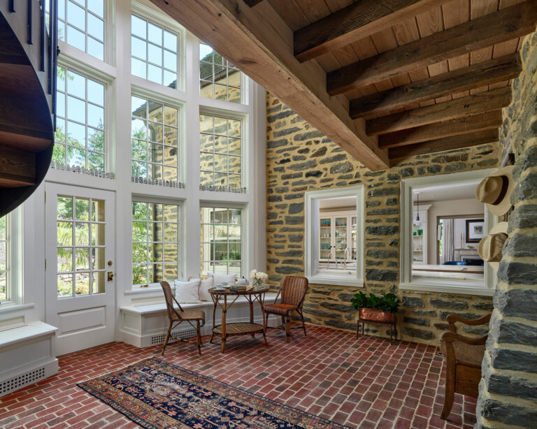 New light and airy atrium connects a new garage to an existing cottage in Gladwyne