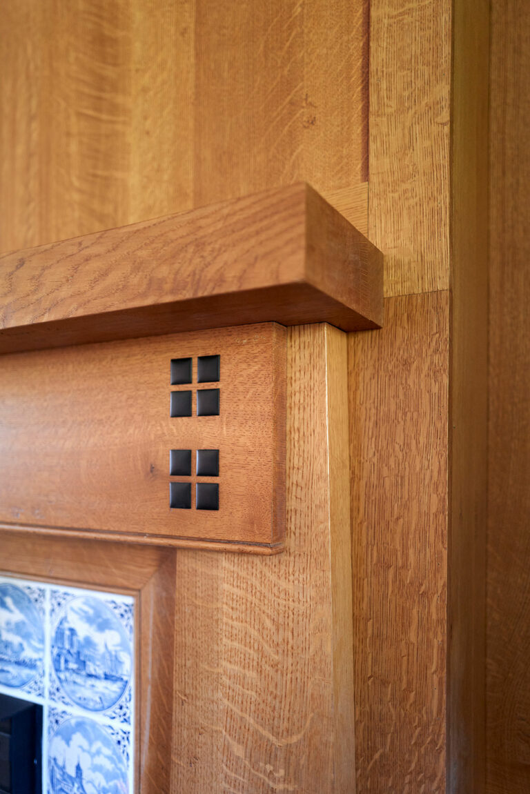 Arts and Crafts Style detailing on a custom wood fireplace mantel and surround