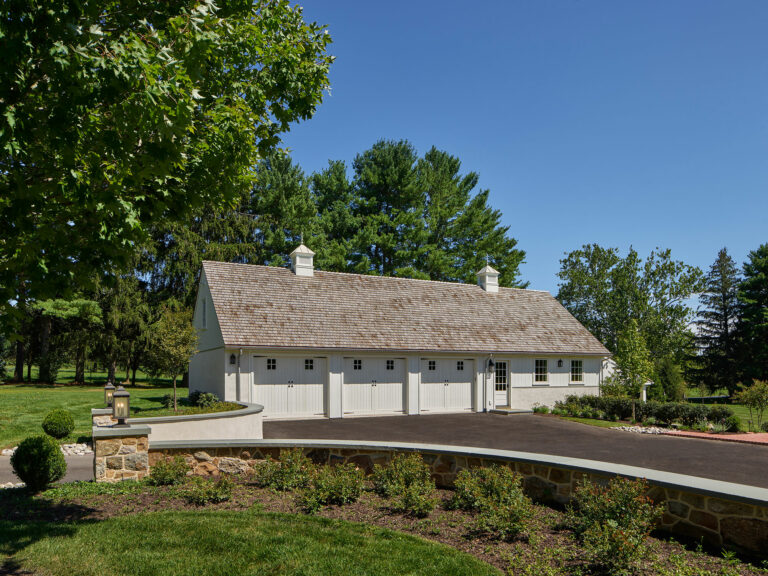 White three bay garage with cupolas at Evergreen Farm