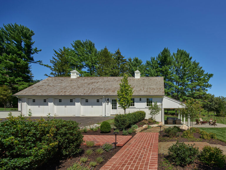 Brick walkway connecting house to garage and outdoor spaces at Evergreen Farm