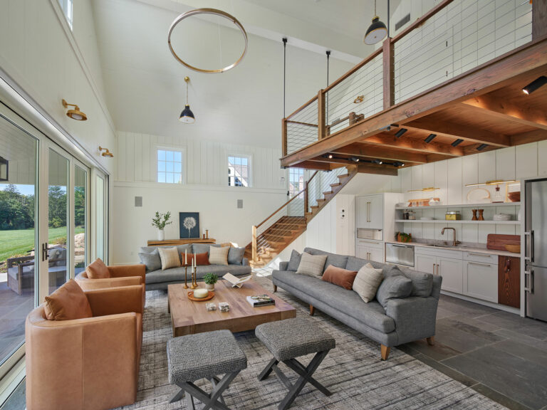 Recreation room with kitchenette and loft connected to outdoor patio with large sliding glass doors at Evergreen Farm