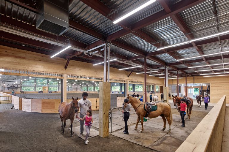 Horses and riders in tie area at Chamounix Stables McCausland Arena for Work to Ride program