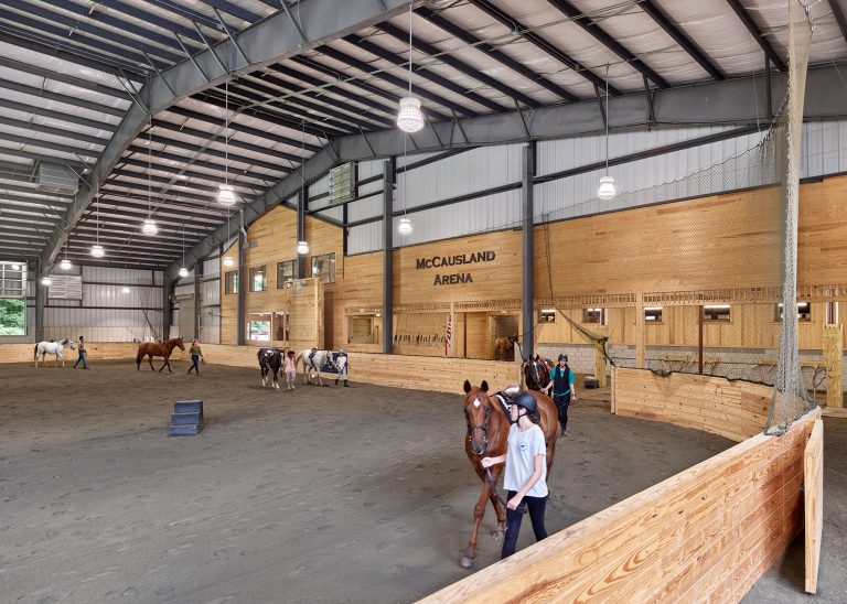 Riders and horses walking in Chamounix Stables McCausland Arena for Work to Ride program