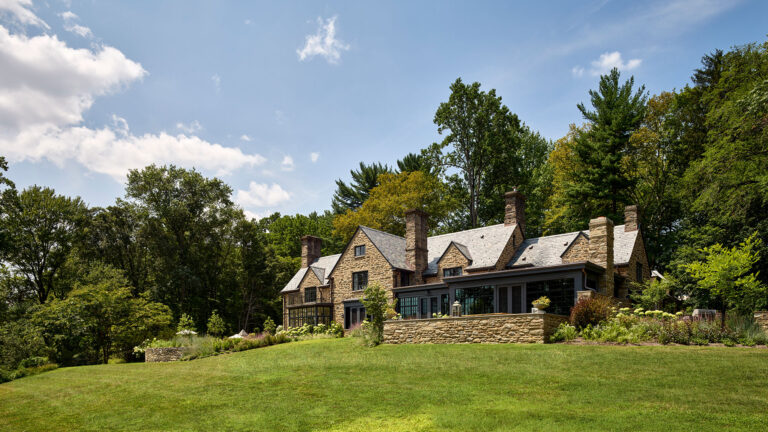 Main Line Manor view of rear exterior terrace and additions in Gladwyne